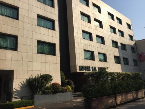 a building with a sign on the side of it at Hotel La Luna in Mexico City