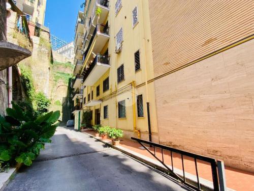an empty street in an alley between buildings at Joma House in Chiaia