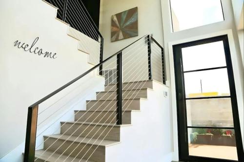 a staircase in a house with a metal railing at Modern 2-Home Private Oasis w Pool Hot Tub in DT in Austin