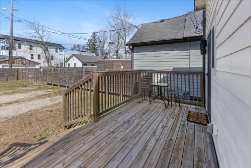 a wooden deck with a table on the side of a house at Cozy Retreat in Historic Indianapolis Neighborhood Close to Downtown in Indianapolis