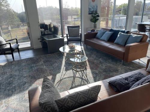 a living room with a couch and a table at Game Day Penthouse Steps from UT Sports in Austin