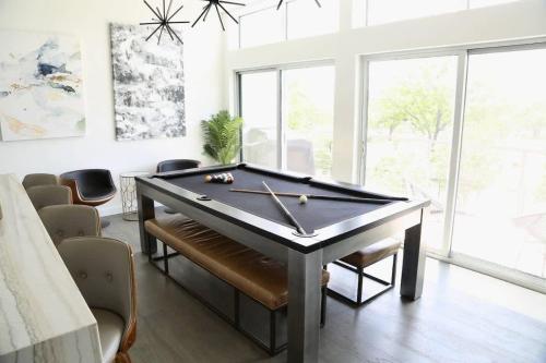 a billiard table in a room with chairs at Tailgate Penthouse 2 Blocks from UT Stadium in Austin