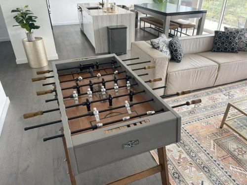 a foosball table in the middle of a living room at Tailgate Penthouse 2 Blocks from UT Stadium in Austin