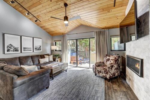 a living room with a couch and a table and chairs at Luxury Modern Townhome-Private Hot Tub-In Town in Breckenridge