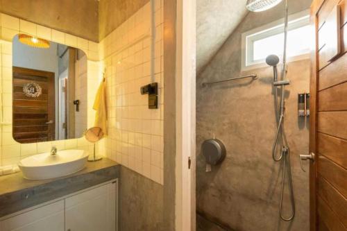 a bathroom with a sink and a shower at Cape Ratchada. in Bangkok