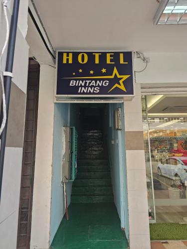 a sign for a hotel with a stairway into a building at Hotel O Bintang Inns in Rawang