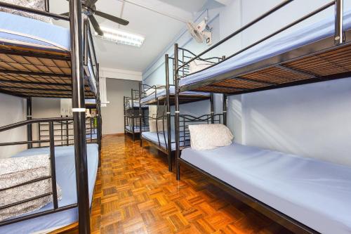 a group of bunk beds in a dorm room at Hotel O Kuantan Backpackers in Kuantan