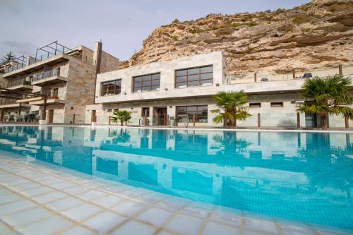 a large swimming pool in front of a building at Hotel Spa Elia in Alcalá del Júcar