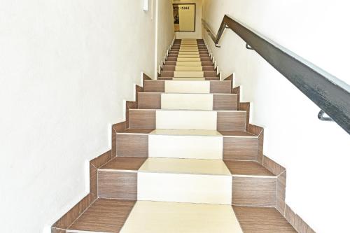 a staircase in a building with wooden floors at Hotel O Mini Indah in Kuala Terengganu