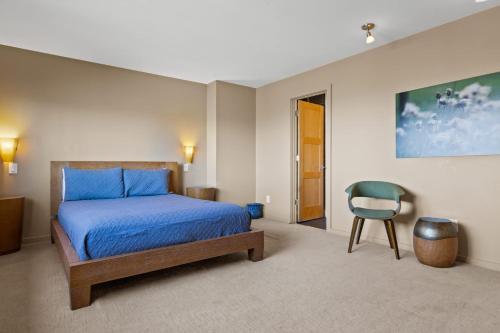 a bedroom with a bed and a chair in it at Mtn Views Sleeps 8 Hot Tub Game Room Fireplace in Blue Ridge