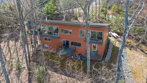 an orange house on the side of a hill with trees at Mtn Views Sleeps 8 Hot Tub Game Room Fireplace in Blue Ridge