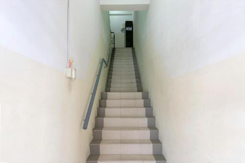 a stairway leading up to a hallway with a stair case at Hotel O V Stay Guesthouse in Ayer Itam