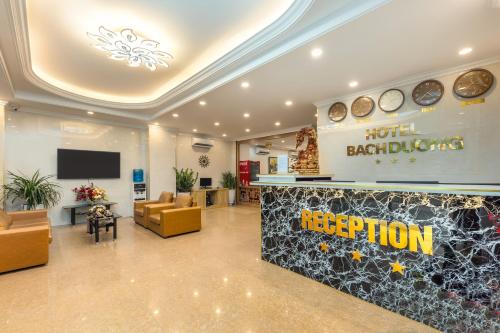 a hotel reception area with a hotel bagleton reception desk at Super OYO Capital O 387 Bach Duong Hotel in Hanoi