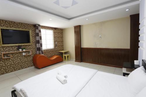 a room with two beds and a flat screen tv at Avatar Hotel in Ho Chi Minh City