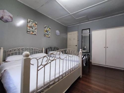 a bedroom with a white bed in a room at Hotel O Rb Homestay & Farms in Kuching