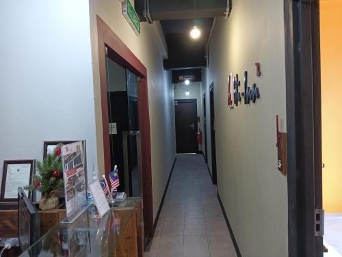 a hallway with a hallway leading to a room at Hotel O Hi Inn 2 in Sibu