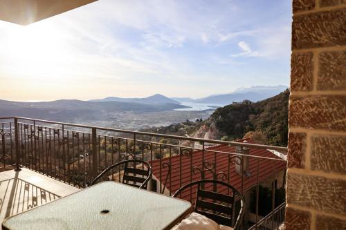 a balcony with a table and chairs and a view at Villa Mia in Kotor