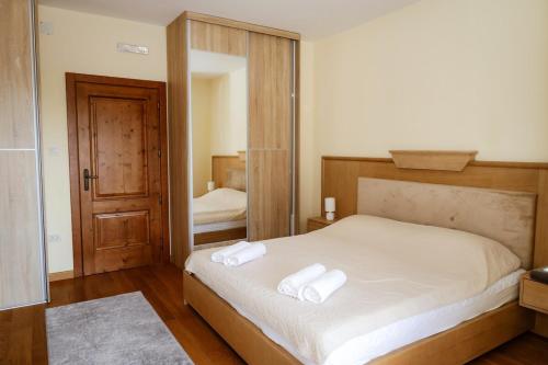 a bedroom with a bed with two towels on it at Villa Mia in Kotor