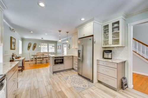 a kitchen with stainless steel appliances and a dining room at 1 Mi to Okemo Mtn Resort Ludlow Home with Hot Tub in Ludlow