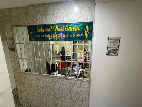 a restaurant window with a sign on a wall at Hotel O 59 in Sibu