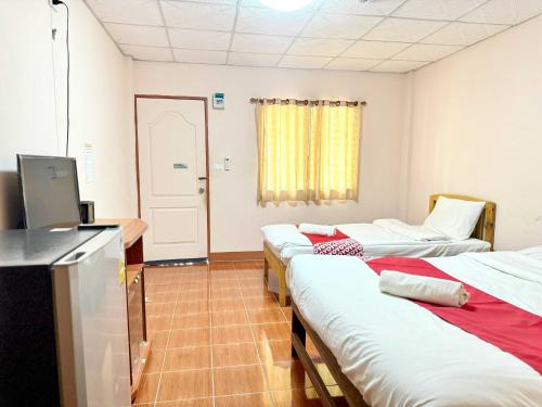 a hospital room with three beds and a television at Honeyland Resort in Chiang Mai