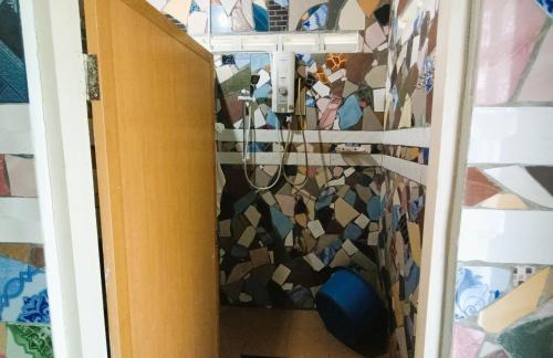 a room with a wall covered in mosaics at Hotel O Flinstone Lodge in Kota Kinabalu