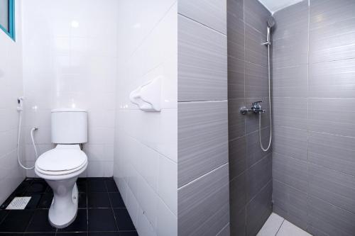 a bathroom with a toilet and a shower at Hotel O Lm Residence in Miri