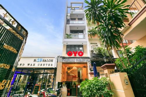 a tall white building with a xo sign on it at Super OYO 520 Friendly Homestay in Ho Chi Minh City