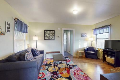 a living room with a couch and a tv at Greenwood Beach Cottage in Elk