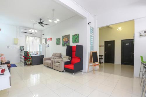 a living room with a couch and a chair at Hotel O Come Inn Premium in Kuala Terengganu