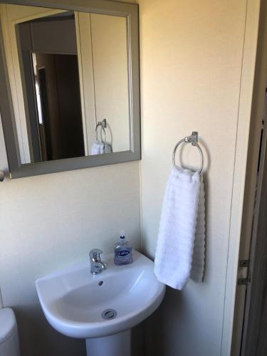 a bathroom with a white sink and a mirror at Relaxing Retreat with Hot Tub in Saint Helens