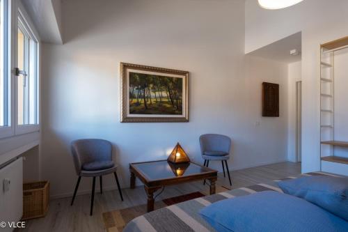 a bedroom with a bed and two chairs and a table at Varenna My Love in Varenna