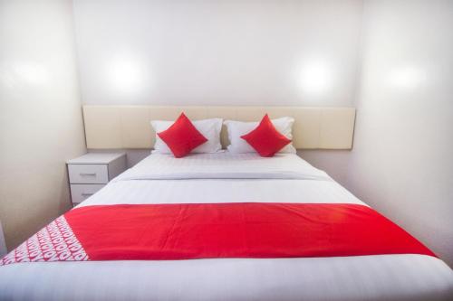 a red and white bed in a room at Hotel O iBC36 Business Stay in Kuching