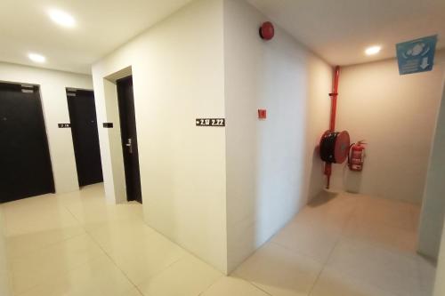 a hallway with a fire hydrant on a wall at Hotel O Hi Inn in Sibu