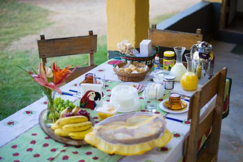a table with a plate of food on it at Fazenda Santa Thereza - Itapira in Itapira