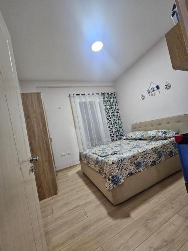 a bedroom with a bed and a window and a door at Holidays Home Priam in Golem
