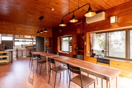 a kitchen with a long wooden table and chairs at Refugio del Café - Vacation STAY 92035v in Iwaki