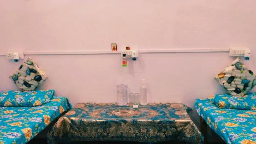a room with two couches and a table at Vardaan Rooms in Prayagraj