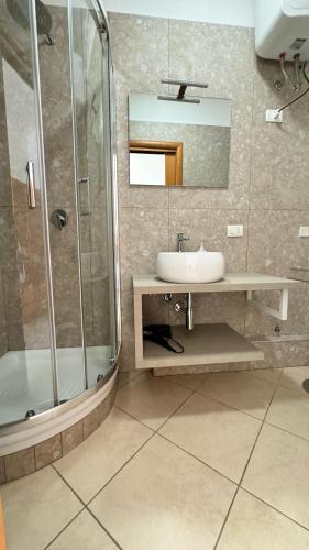 a bathroom with a sink and a shower at L'Approdo in San Leone