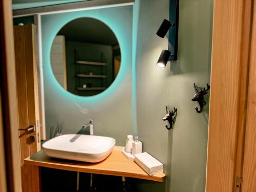 a bathroom with a sink and a mirror at Camping Ursulet Durau in Ceahlău