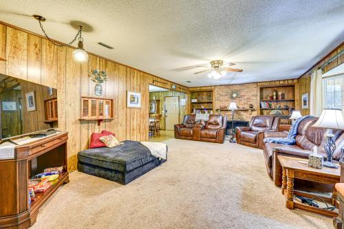 a living room with leather furniture and a tv at Vintage Chipley Getaway on Large Private Property in Chipley