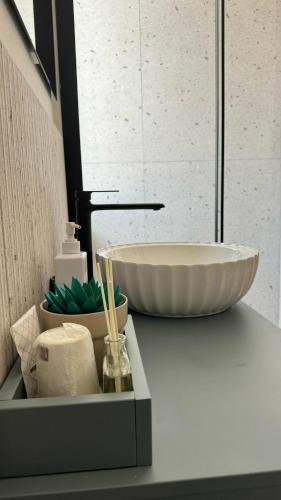 a bathroom counter with a sink and a bowl at L'Approdo in San Leone