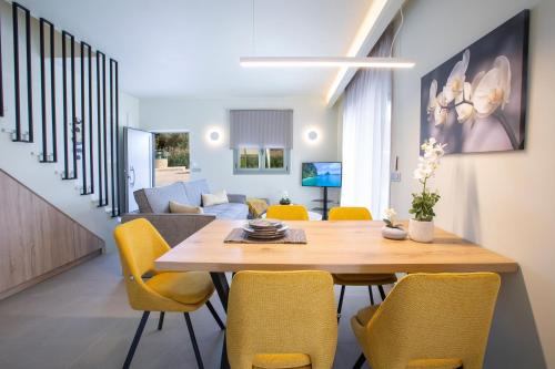 a dining room and living room with a table and chairs at Valley House in Vasiliki