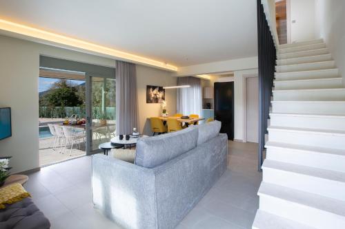 a living room with a couch and a staircase at Valley House in Vasiliki