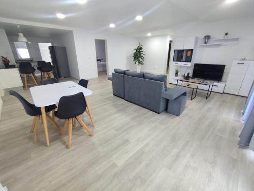 a living room with a couch and a table and chairs at Azores Blue Bay II in Madalena