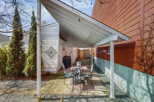 a patio with a table and two chairs under awning at White House in Ferndale