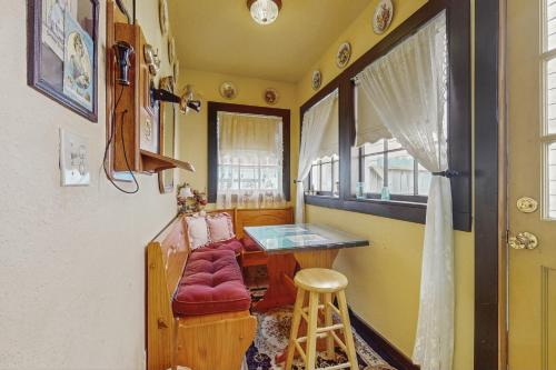 a room with a table and a chair and a window at White House in Ferndale