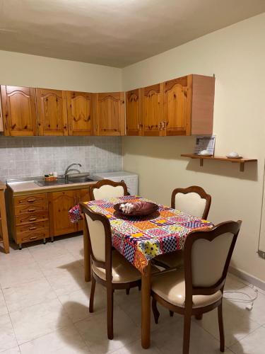 a kitchen with a table with chairs and a table cloth at La Casetta da Silvia in Bisceglie