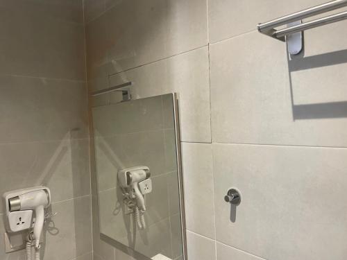 a bathroom with a mirror and a phone on the wall at Casas Del Mar Cabo N in Martil