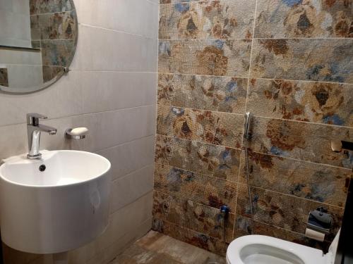 a bathroom with a sink and a toilet at Lahore Luxury Retreats in Lahore